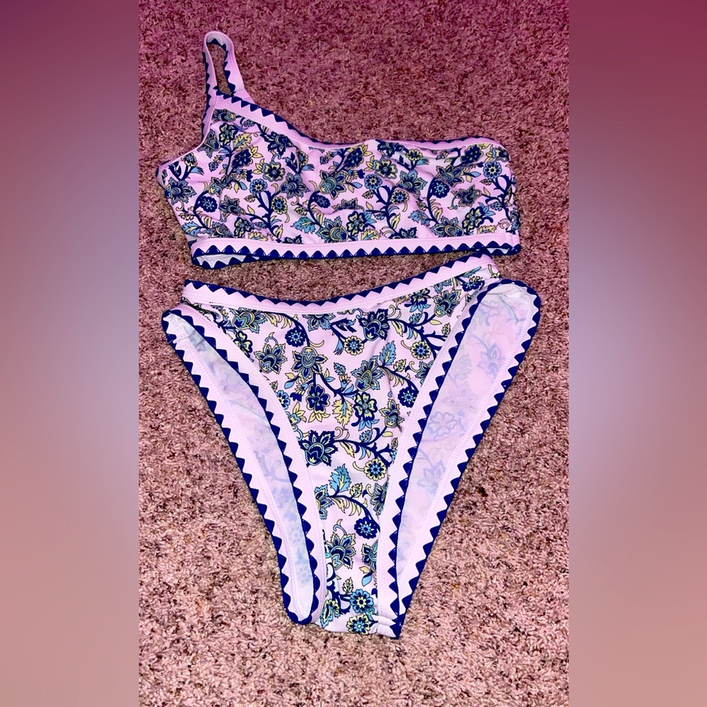 Two piece swim suit, with one shoulder top and high wasted bottoms.